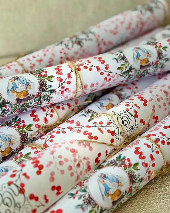 Rolls of O Holy Night cherries wrapping paper tied with twine